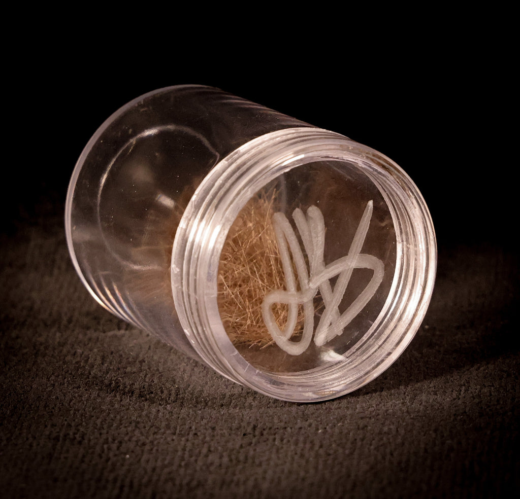 Justin Bieber's hair, presented in a plastic container which has been initialled by Bieber himself. 