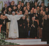 An image of Pope Benedict XVI stood on a red carpet.