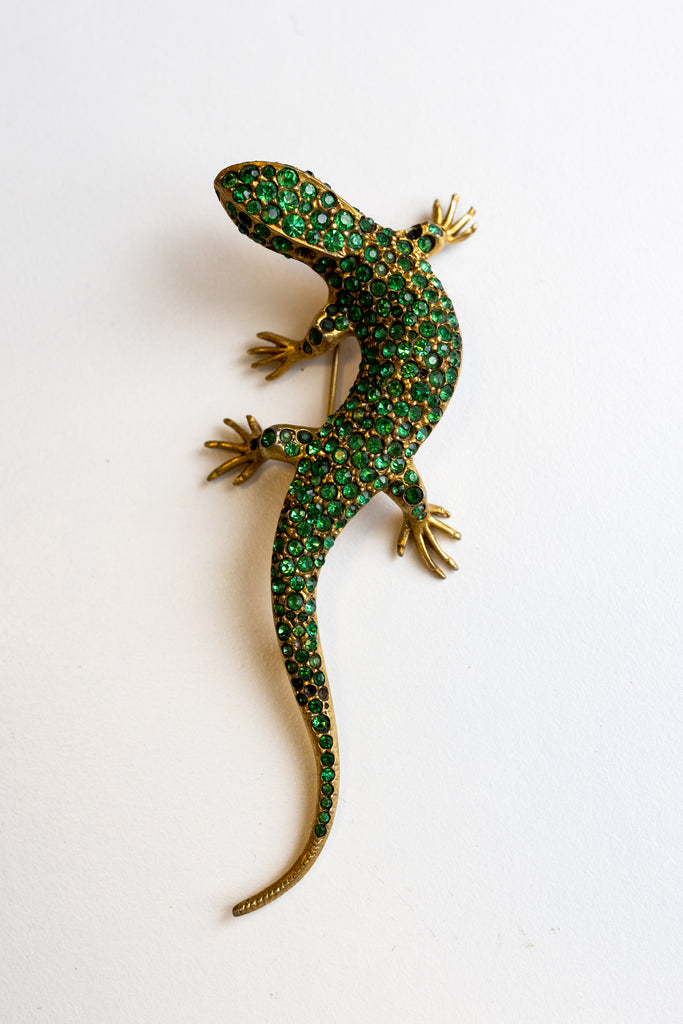 A vibrant green lizard brooch featuring green and gold crystals, previously belonging to Fidel Castro's mistress.