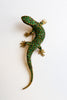 A vibrant green lizard brooch featuring green and gold crystals, previously belonging to Fidel Castro's mistress.